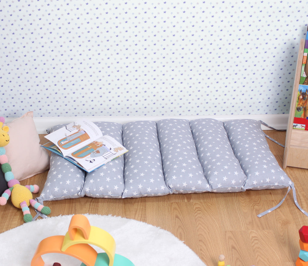 a child's room with a bed and toys on the floor