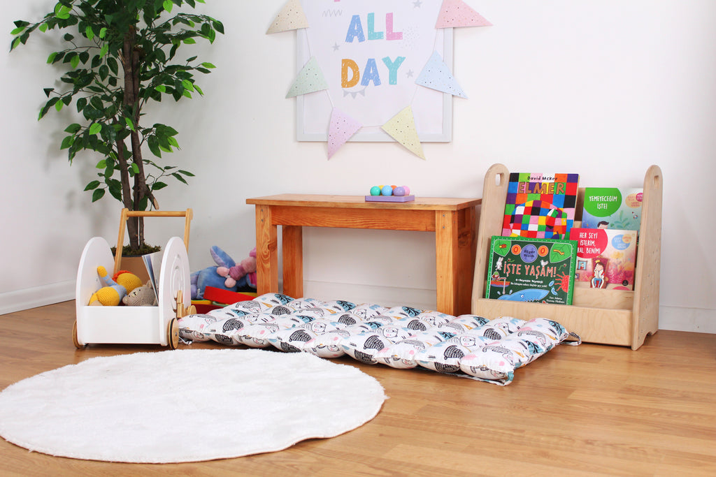 a child's playroom with toys and a potted plant