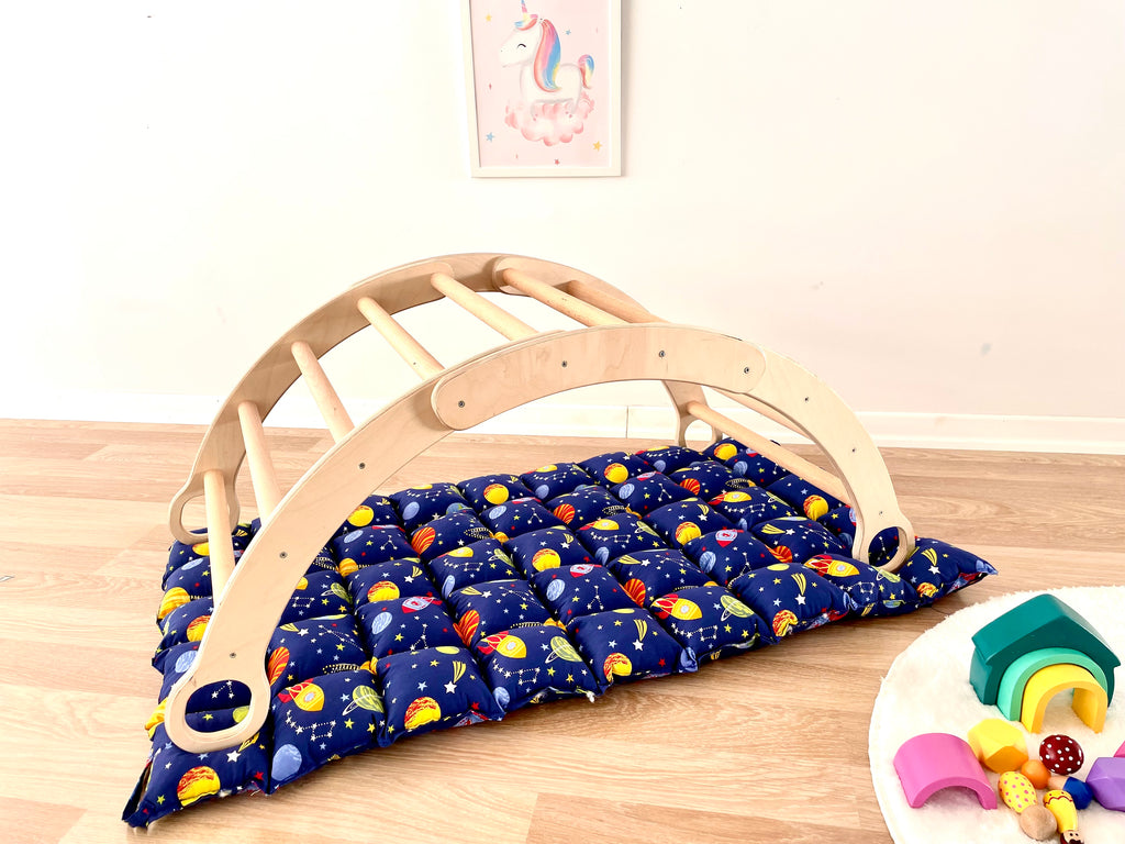 a child's bed with a wooden frame and blue fabric