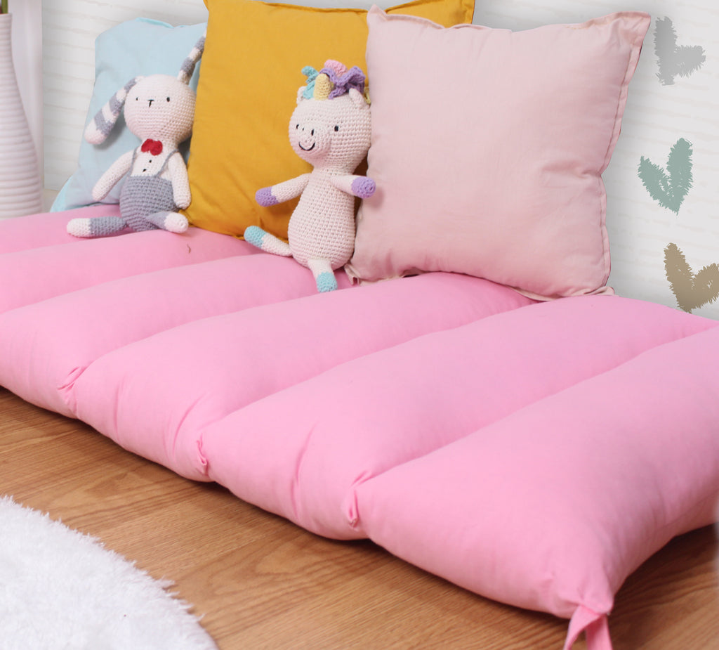 a bed with pillows and stuffed animals on it