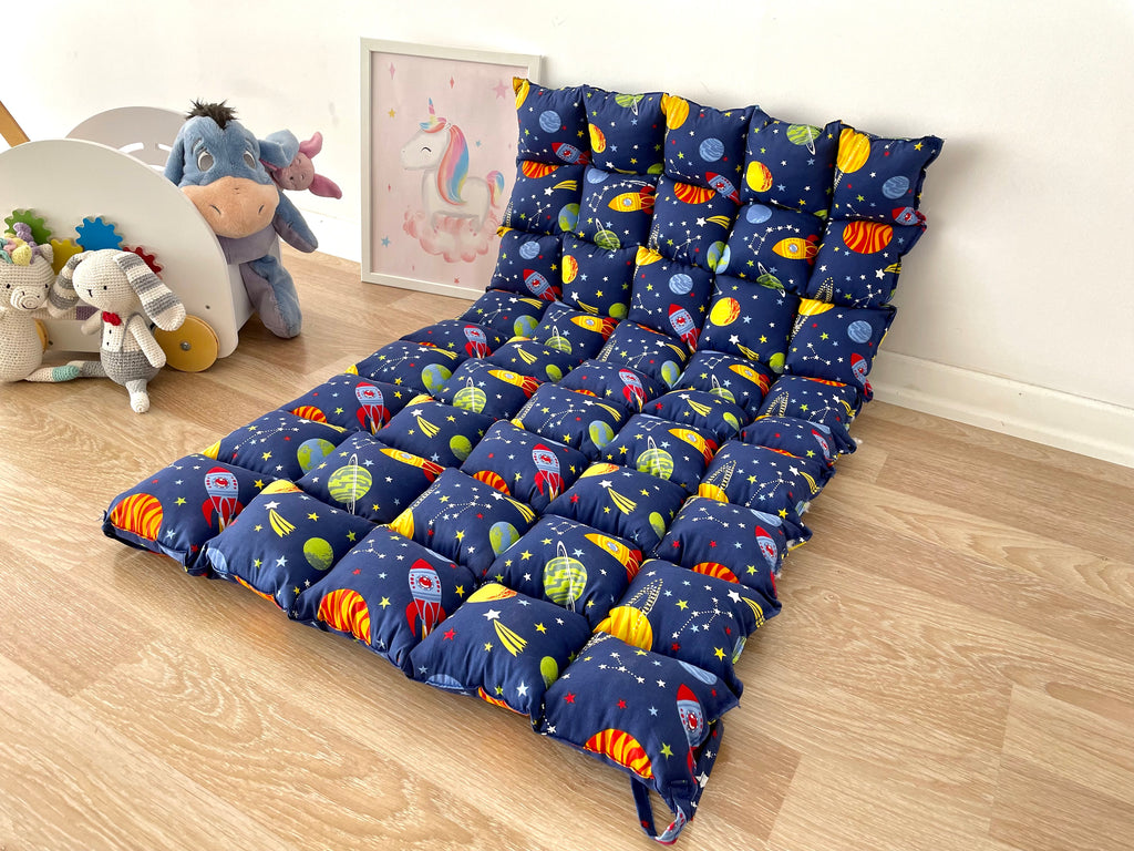 a child's bed with a space theme on it