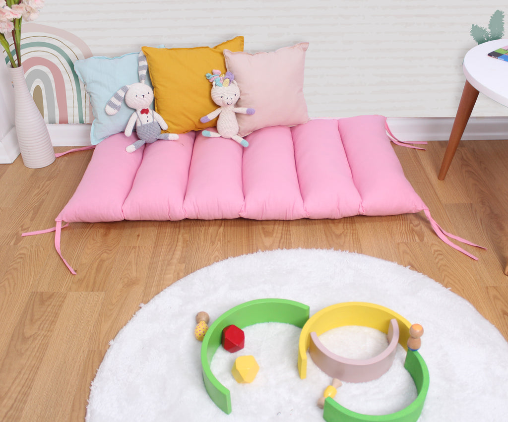 a child's play area with toys and pillows